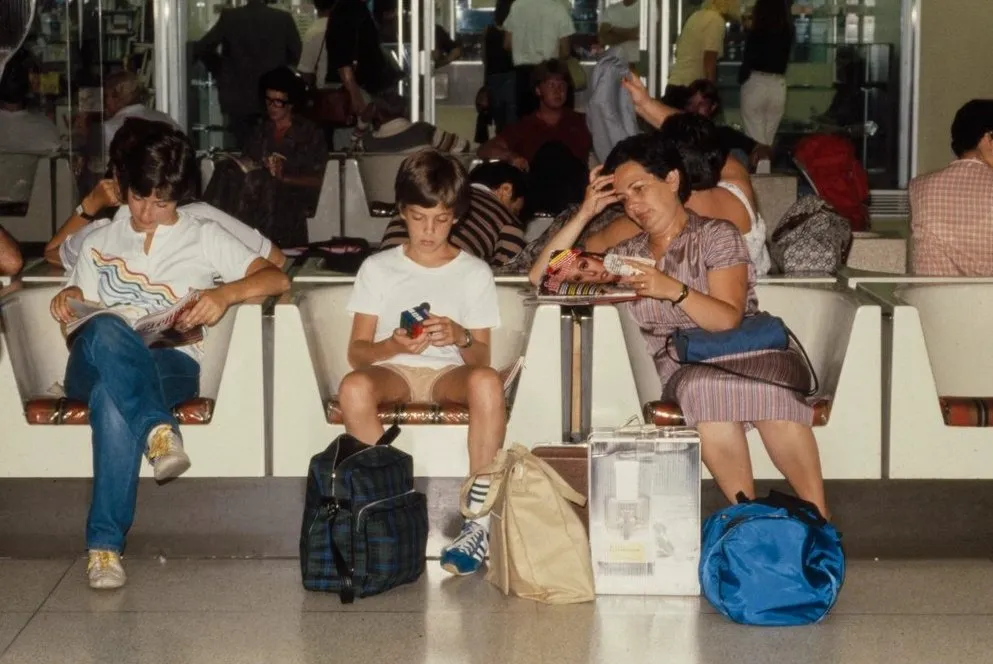 Travellers waiting in an airport terminal