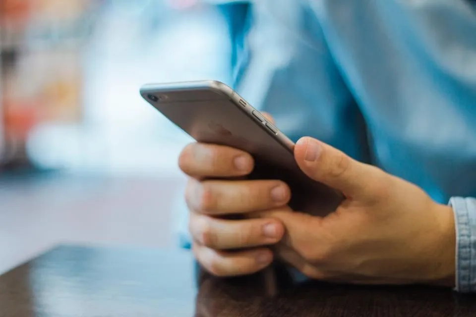 A man scrolling on a smartphone